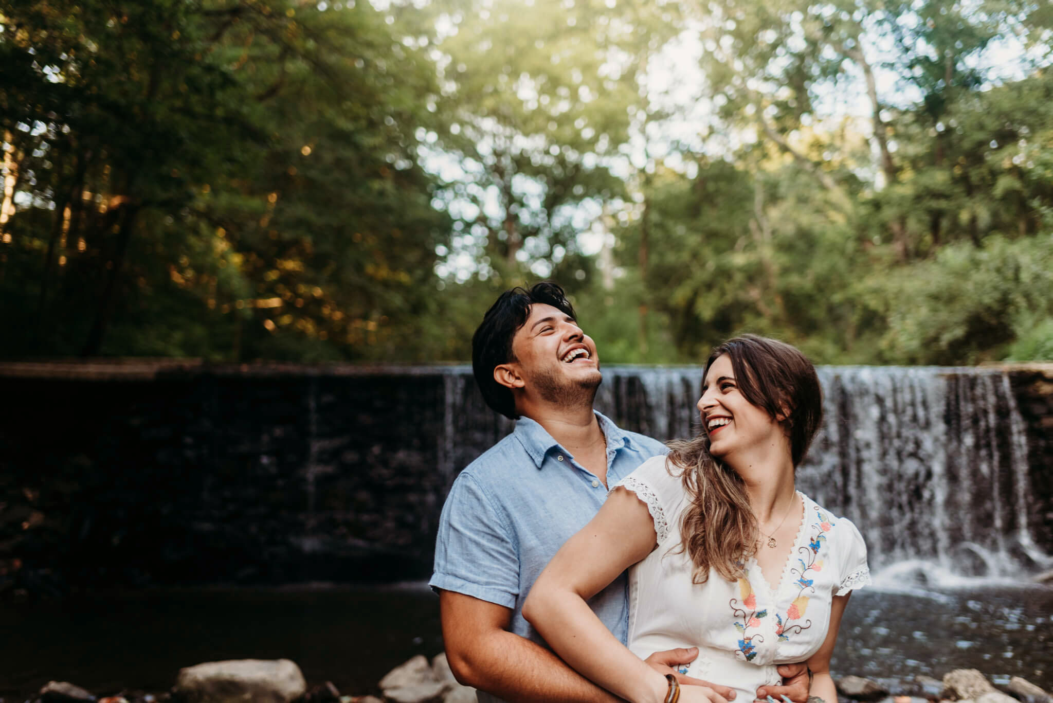 Couple laughing in photo featured in post about Philadelphia date night ideas